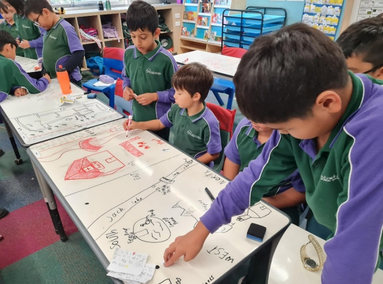 An image of students completing group work at their table