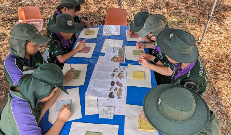 Students sitting at a table during an excursion