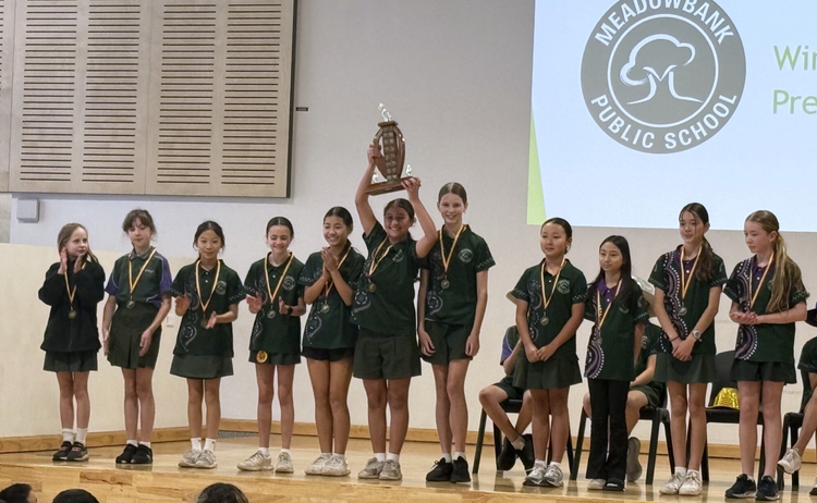 Girl sports team receiving a trophy