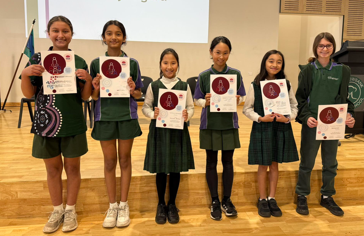 Students in the school hall with public speaking certificates